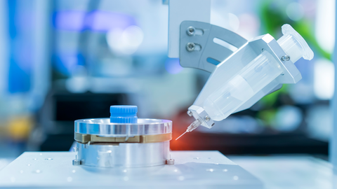 Industrial arm with a syringe dispenses liquid  Industrial arm with a syringe dispenses liquid